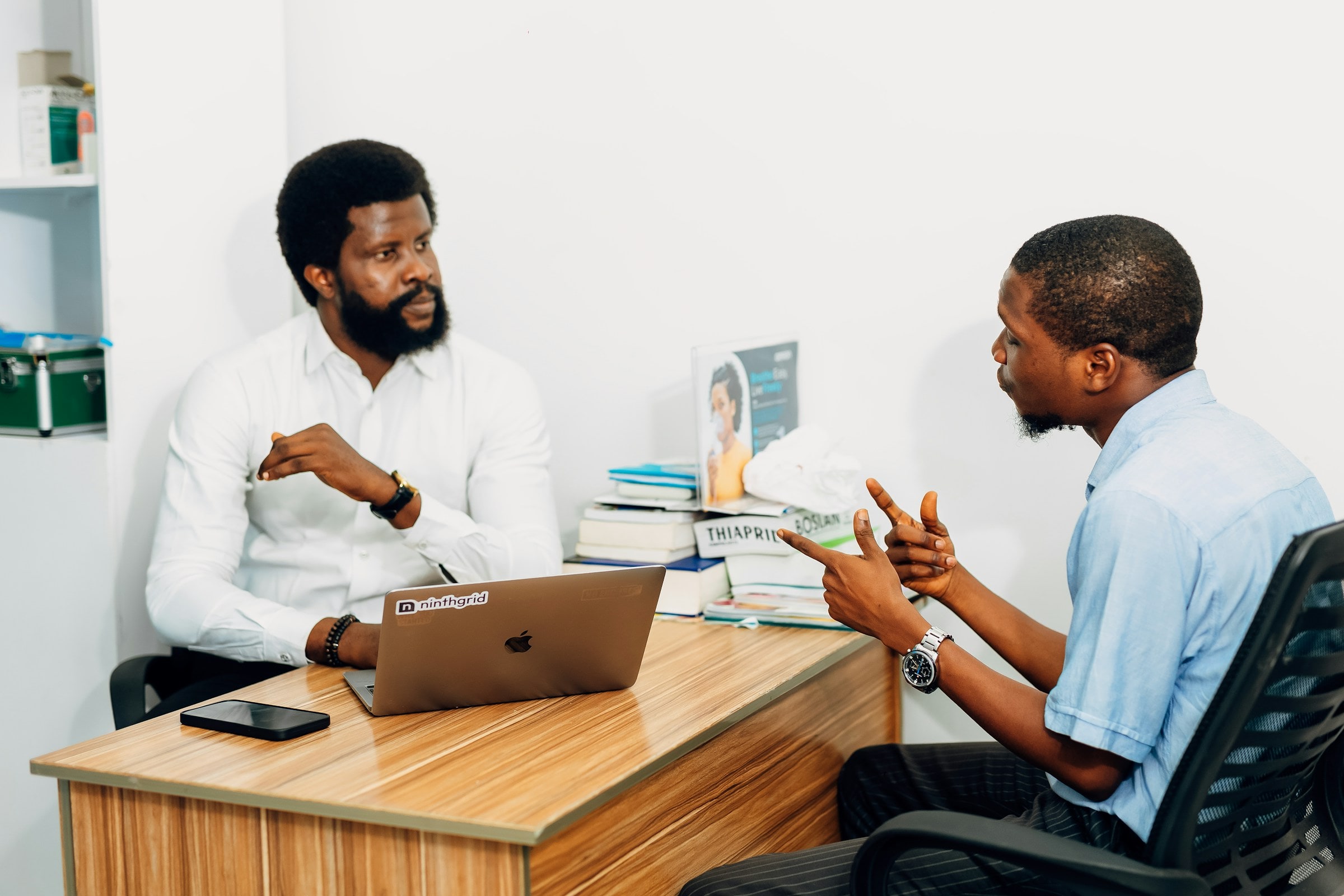 Two colleagues reviewing a monthly report together at a desk