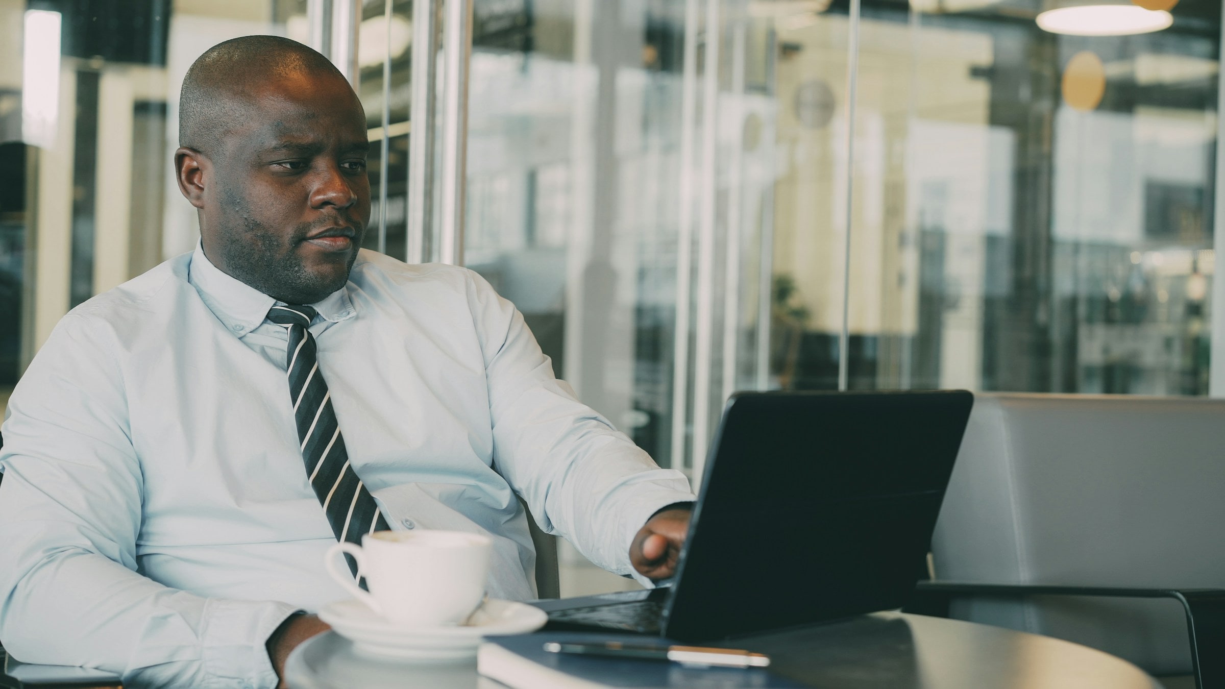A finance professional working through figures on a laptop