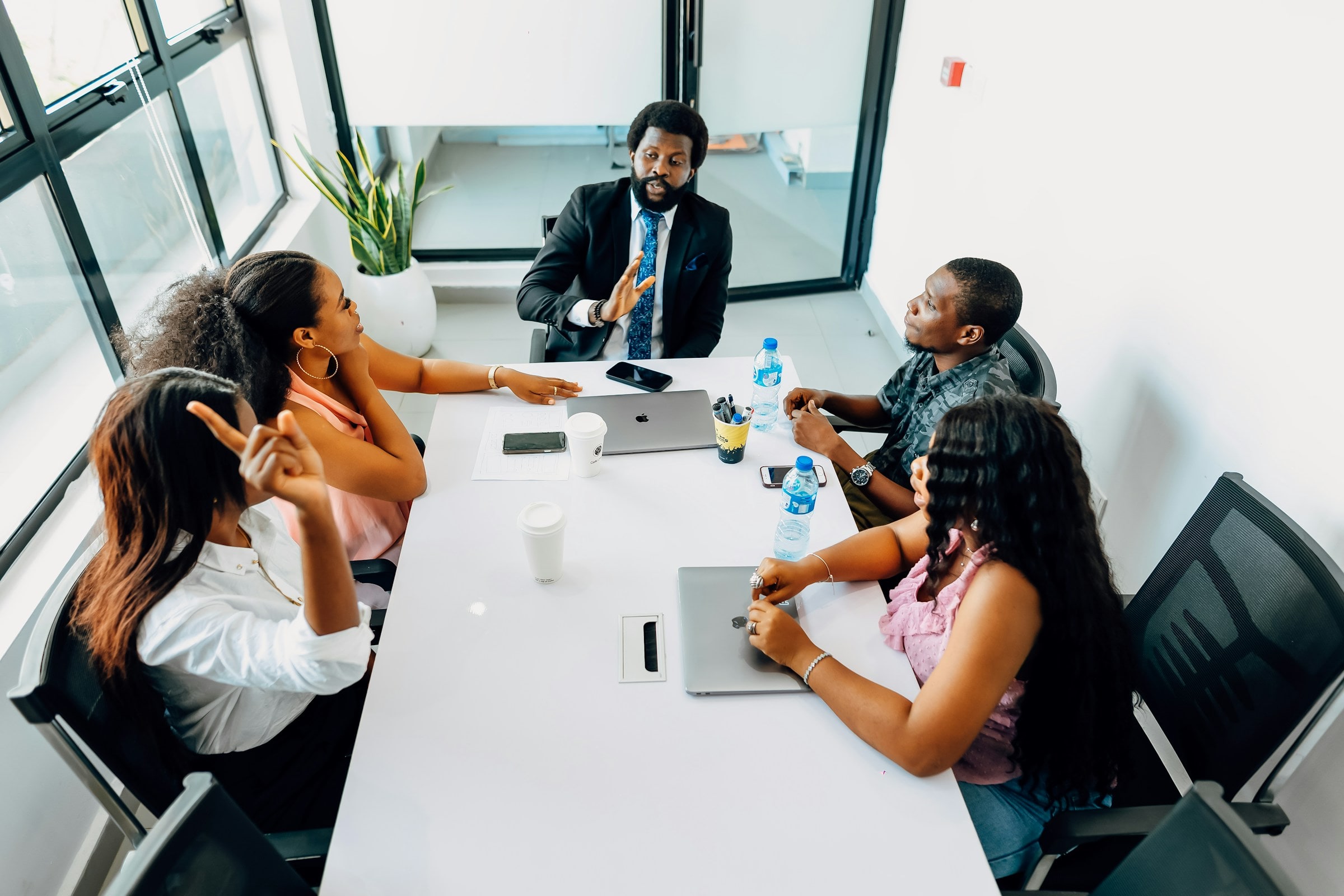 A project team planning a new system around a meeting table