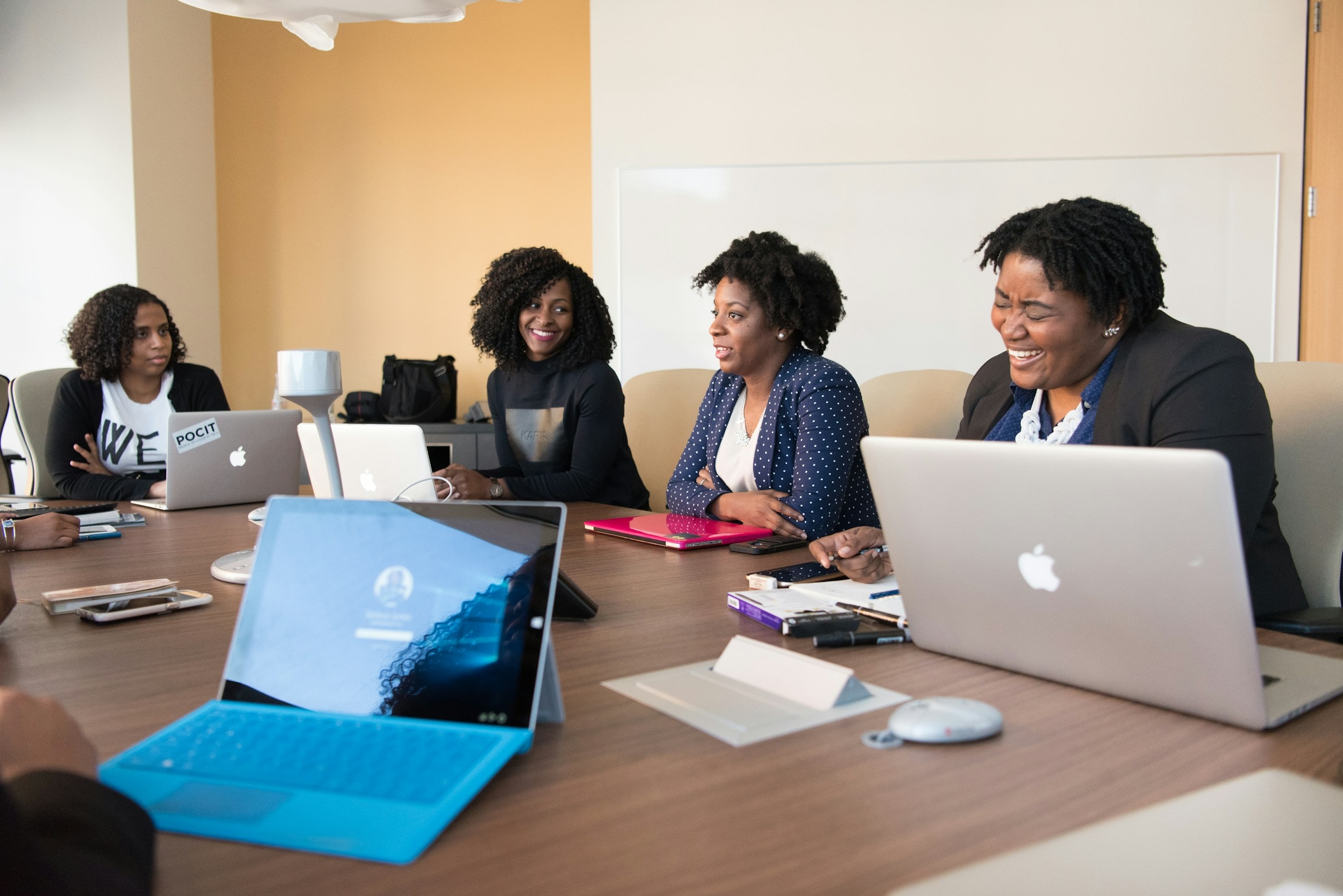 A team working together around a table with laptops